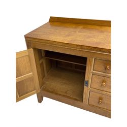 Rabbitman - adzed oak sideboard, fitted with three central drawer and two flanking cupboards, panelled doors with iron latches and hinges, carved with rabbit signature, by Peter Heap, Wetwang