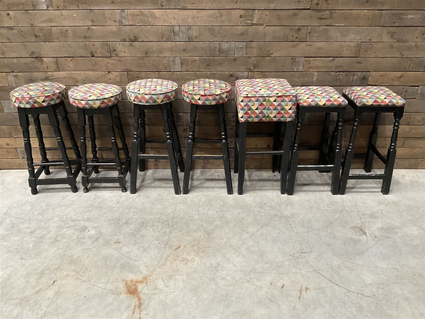 Seven tall bar stools with upholstered seat
