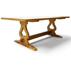 Acorn Industries - oak dining table, rectangular top with rounded corners and chamfered edge, raised on twin lyre-shaped supports united by pegged stretched on sledge feet, carved with acorn signature to stretcher, by Alan Grainger, Brandsby