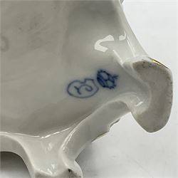 Figure group, probably Volkstedt, modelled as a courting couple seated before a table, the ornate bench and table conforming with and leading from the gilt heightened scrolling base, with blue painted mark beneath, H14.5cm
