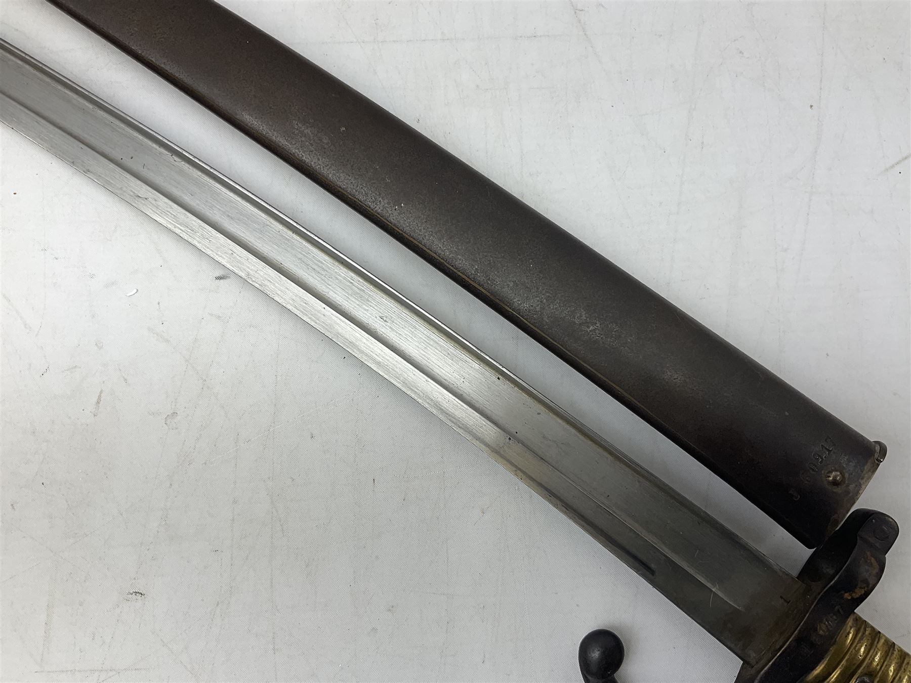 French model 1866 sabre bayonet, the 57.5cm curving blade marked St. Etienne 1868; in associated steel scabbard L71cm overall
