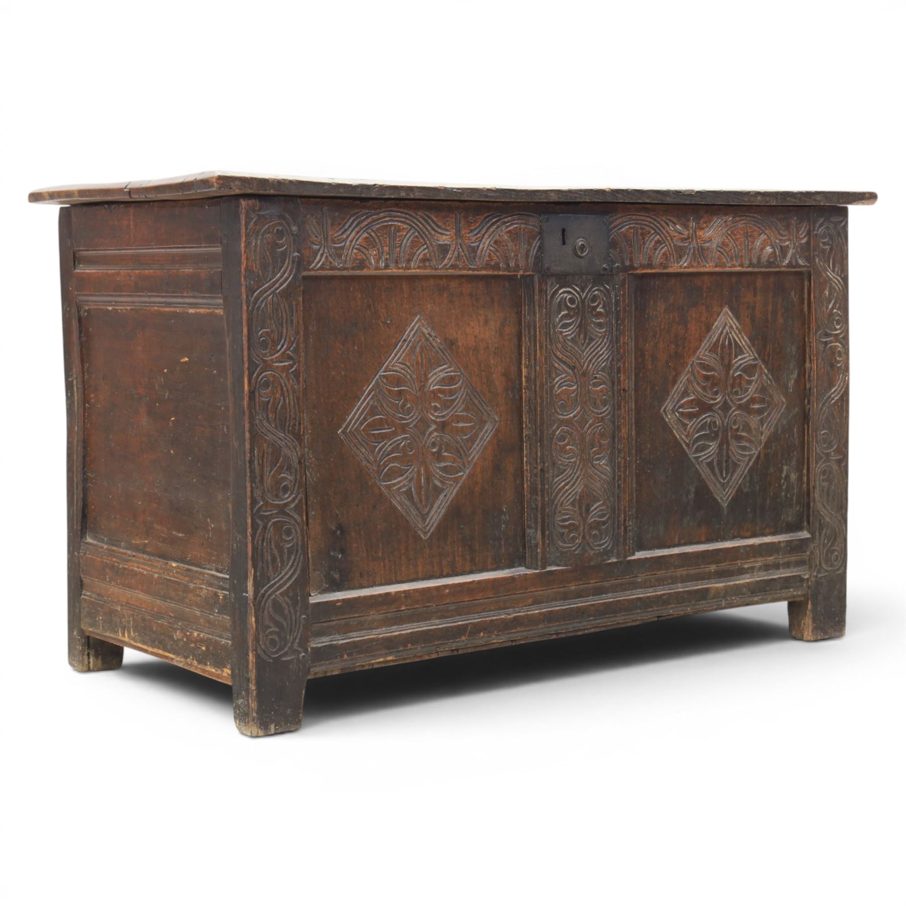 18th century oak coffer with carved frieze and rails, rectangular plank top with iron strap hinges, raised on stile supports