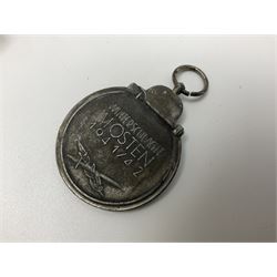 Four German awards - pre-WW2 two-position button hole ribbon for 1914 Iron Cross; WW1 wound badge open back cut-out version with silvered finish; miniature version Mother's Cross with ribbon bow; and The Eastern Medal, officially the Winter Battle in the East 1941–42 Medal (4)