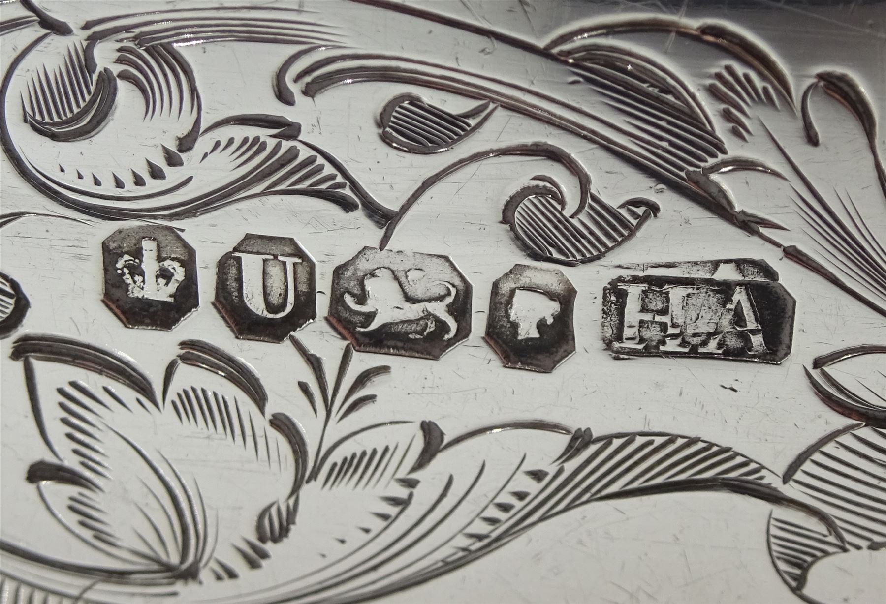 Victorian silver lidded trinket box, with embossed decoration by John Edward Wilmot, Birmingham 1900, silver bladed knife and fork with mother of pearl handles by Atkin Brothers, Sheffield 1862 and an embossed silver dish hallmarked (4)