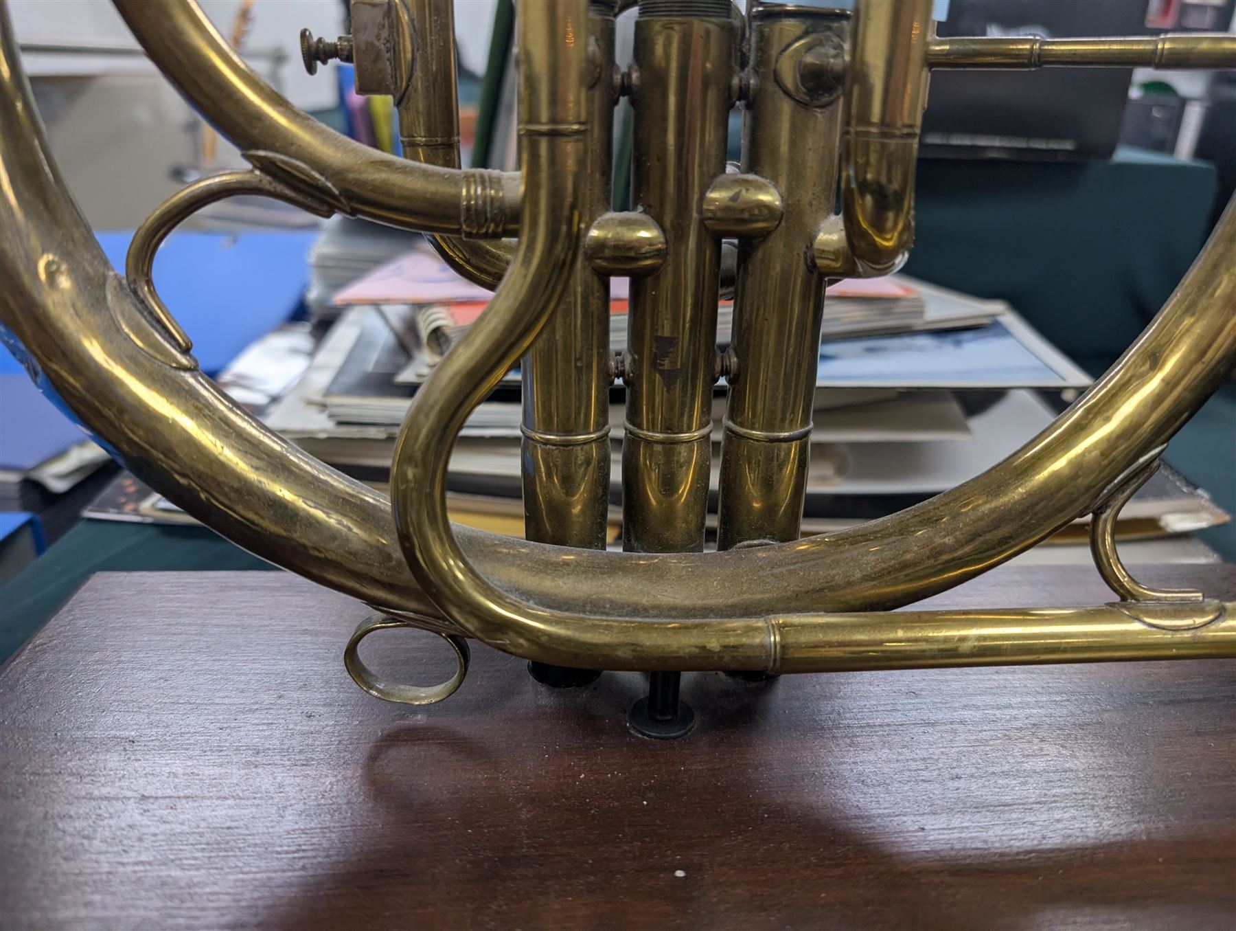 Boosey & Co Ltd French horn, converted into a table lamp, upon a wooden plinth, H45cm