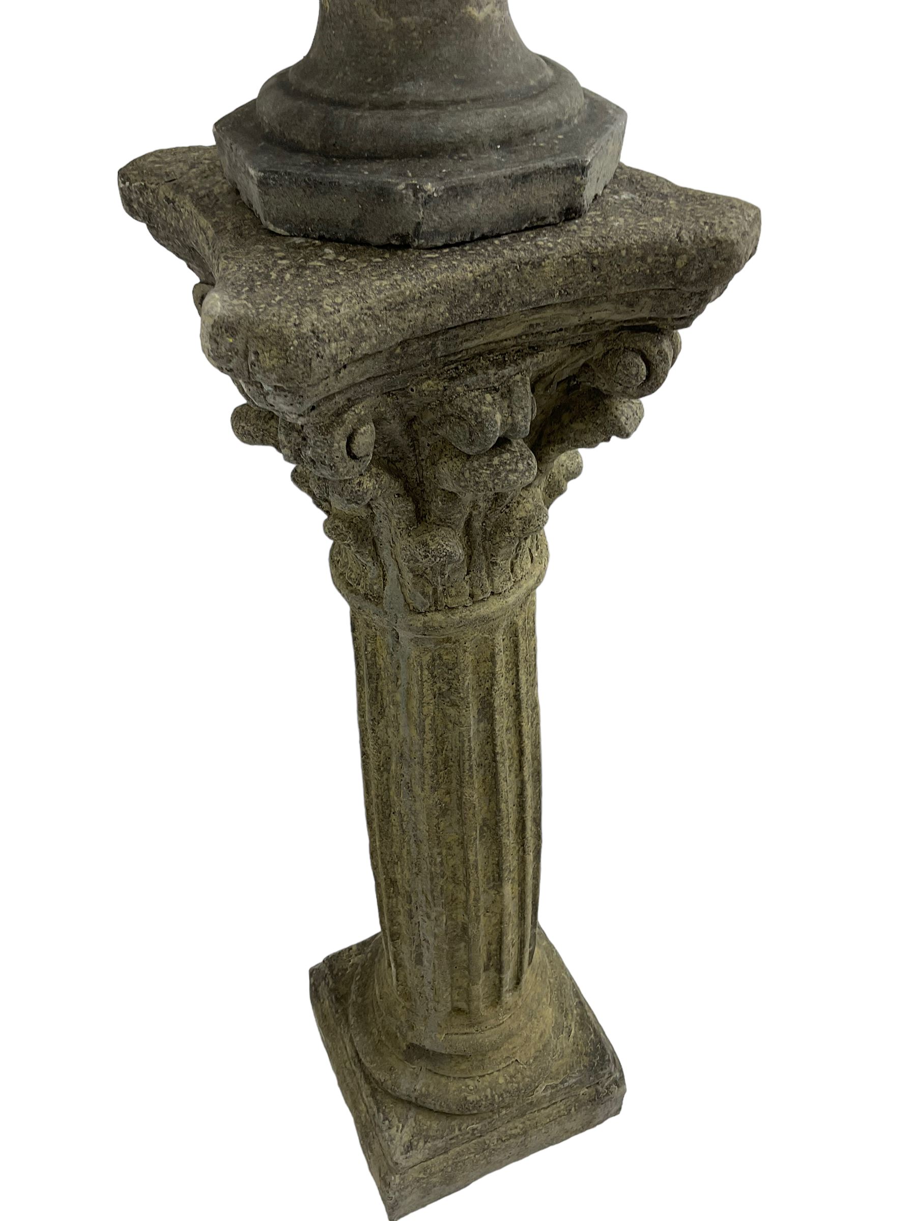 Classical design cast stone female bust depicting Artemis, raised on fluted Corinthian column with acanthus leaf capital, stepped square base, looking right 