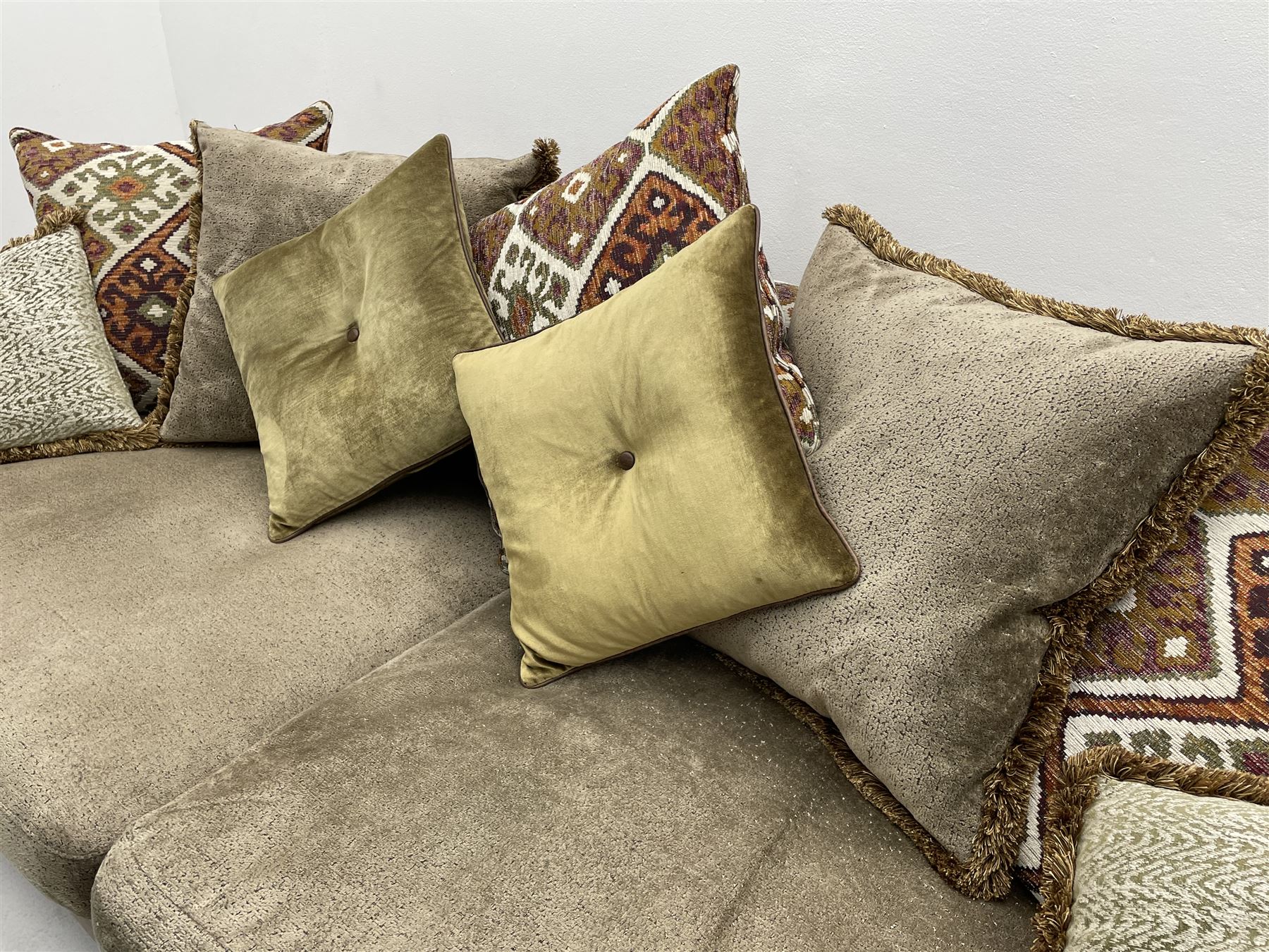 Alexander James - Grand two sectional sofa upholstered in studded leather and fabric, with contrasting kilim patterned scatter cushions, scrolling arms and turned front supports 