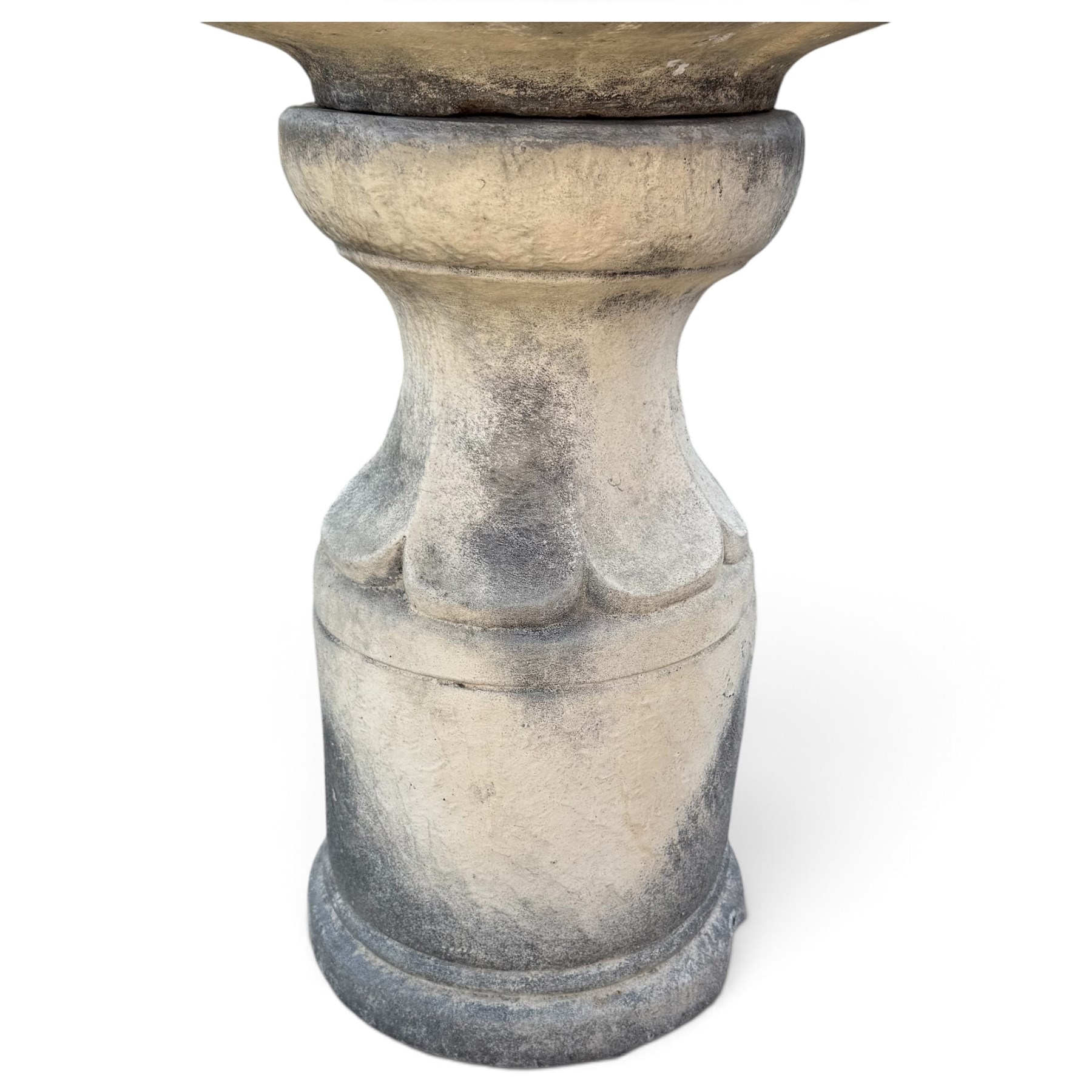Weathered cast stone garden water feature fountain, the raised central spout with egg-and-dart moulding, within a scalloped basin raised on a lappet pedestal with cylindrical plinth base