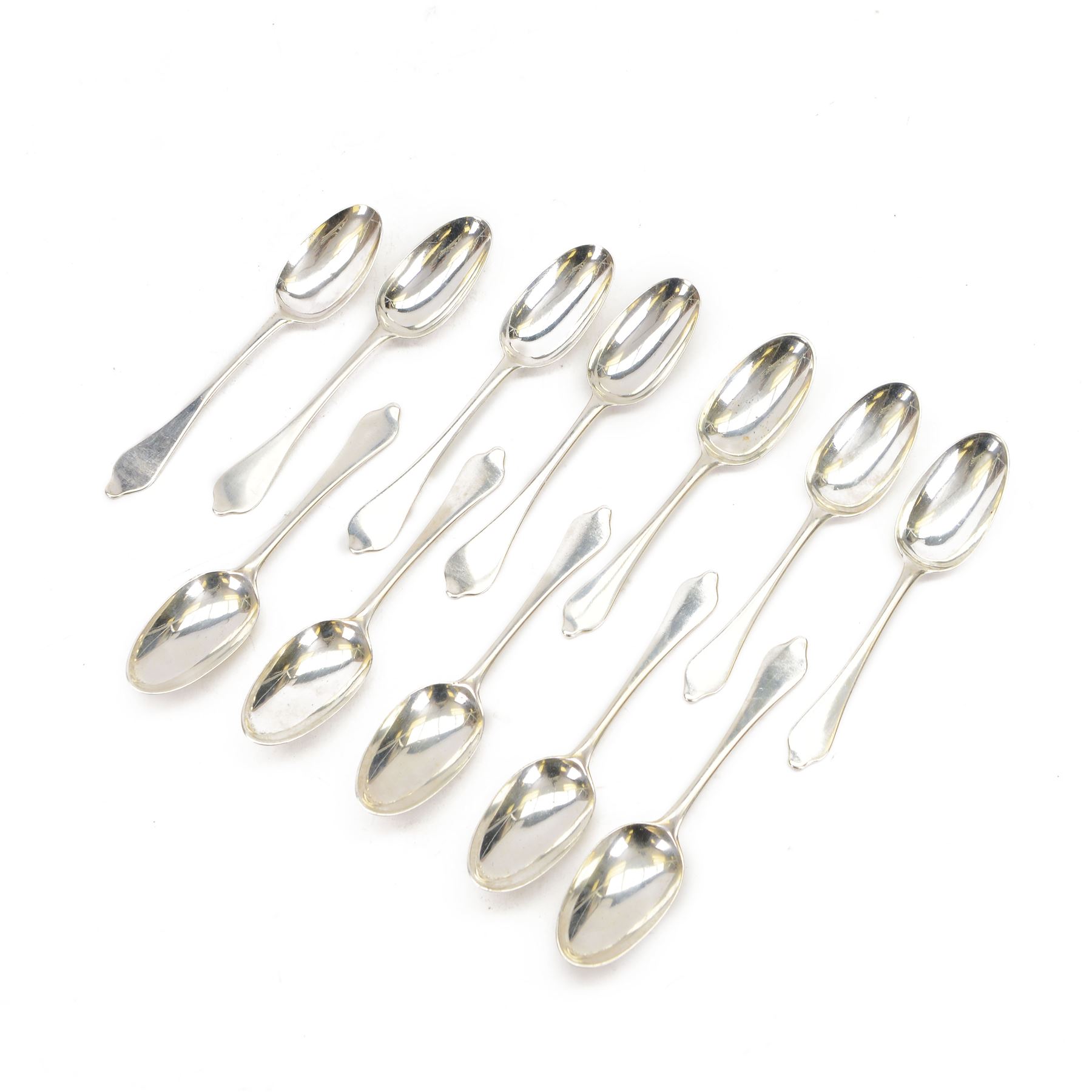 Twelve silver dog nose spoons, comprising a set of eight George II examples with drop heels  and engraved crest to terminals, hallmarked Isaac Callard, London 1732, three with rat tail bowls, circa 1722, hallmarked Samuel Hitchcock, London, date latter worn and indistinct, and a Britannia standard with rat tail bowl, circa 1718, each approximately L20cm
