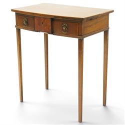 George III mahogany bowfront side table, fitted with single frieze drawer with brass lion-mask handles and twin candle-rests to each side, lower reeded edge on square tapering supports