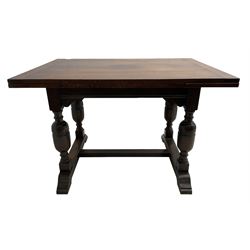 Mid-20th century medium oak dining table, rectangular draw-leaf extending top, quadruple turned pillar supports on sledge feet joined by stretcher