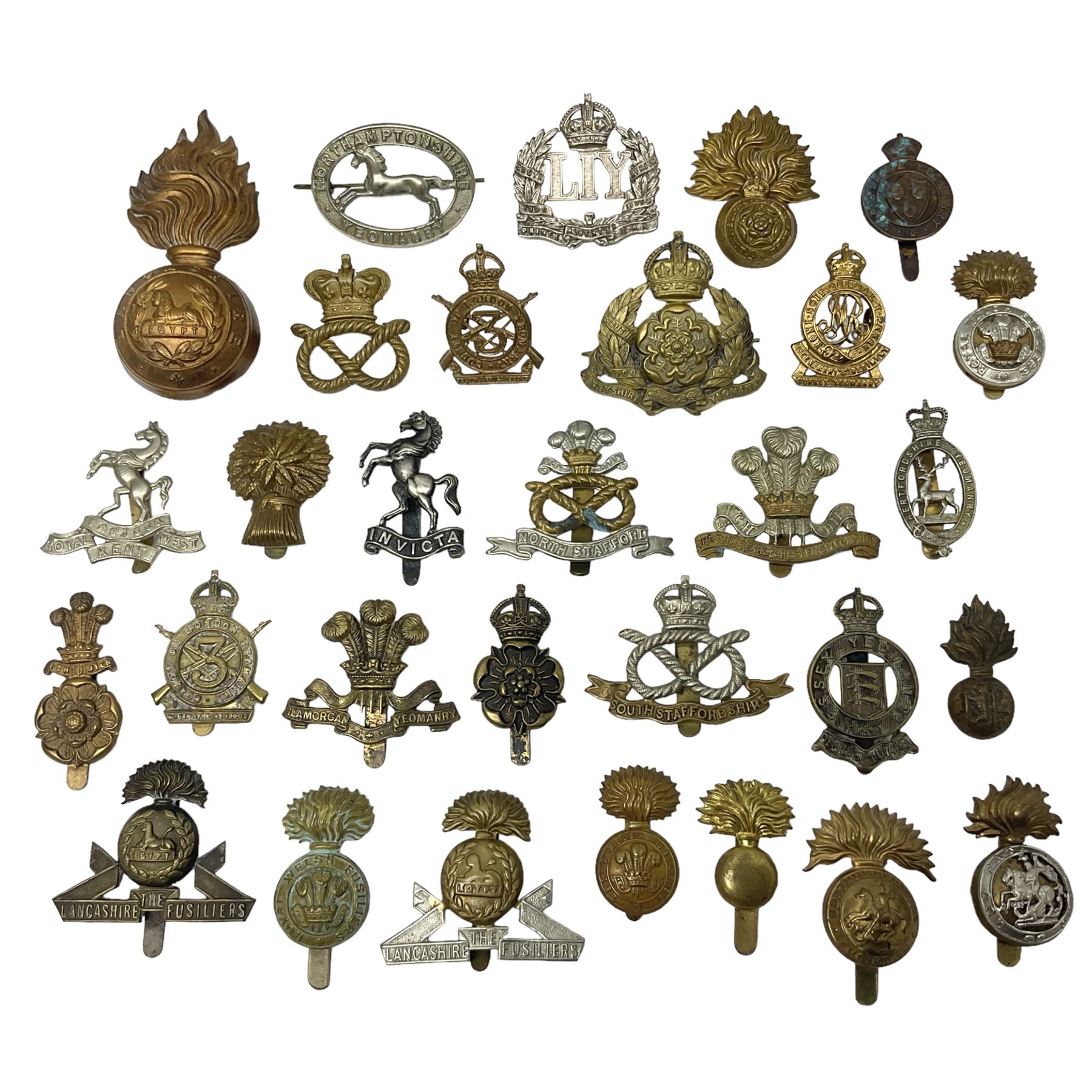 Nineteen Yeomanry metal cap badges including Derbyshire, Northamptonshire, Essex, Glamorgan, Staffordshire, City of London, Surrey, Shropshire, Hertfordshire etc; together with eleven Fusiliers badges including Lancashire, Royal Welch, Northumberland etc (30)