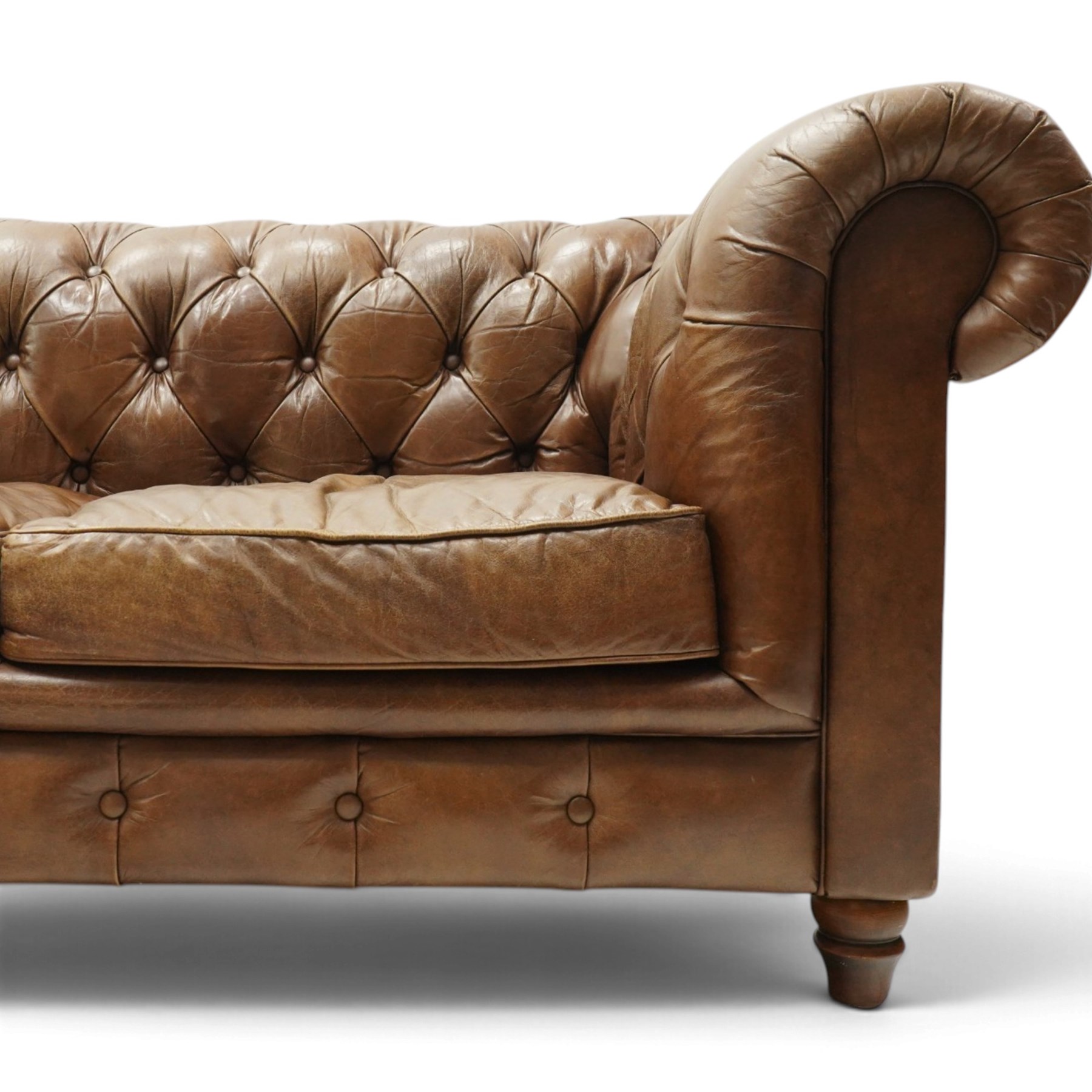 Timothy Oulton for Halo - two seater brown leather chesterfield settee, of traditional shape with rolled back and arms, upholstered in back-buttoned tan leather with loose seat cushions, raised on turned feet