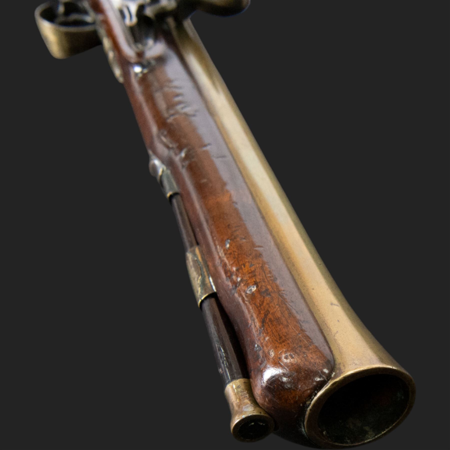 English flintlock blunderbuss, circa 1780 by R. Sutherland of London, the 32cm brass barrel with proof marks and London to the top, with original ramrod with brass tip below, the lock engraved Sutherland, walnut stock with brass butt plate, steel trigger guard with acorn finial, overall L70cm  