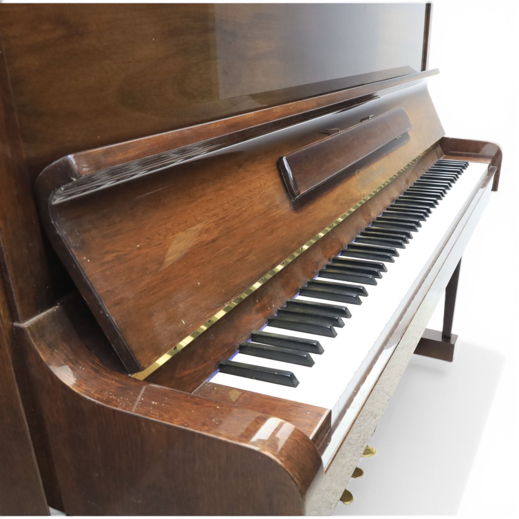 Bluthner of Leipzig upright piano, mahogany case with 88 keys and three brass pedals