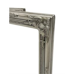 Pair bevelled edge wall mirrors in swept silvered frames decorated with ornate cartouches 