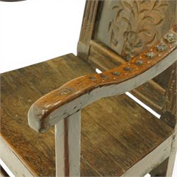 17th century Carolean oak Wainscot chair, the pokerwork cresting rail with carved geometric decoration, over a foliate carved back panel with arcade carved uprights, the arms with repeating guilloche carvings, raised on square chamfered supports united by castors