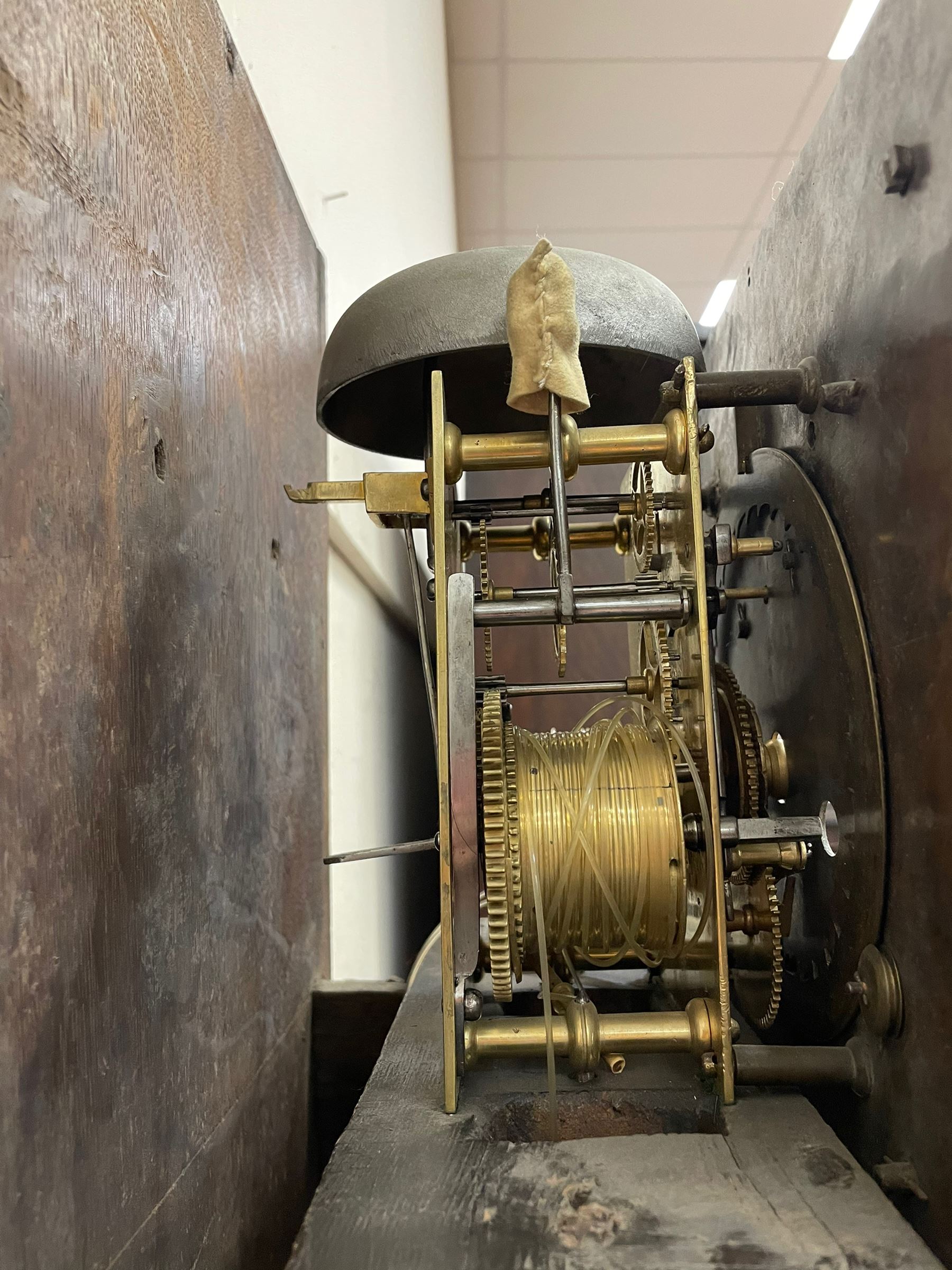 William & Mary floral marquetry 8-day longcase clock c 1700, later mid-18th century four pillar rack striking movement with a square brass dial and subsidiary seconds dial, ringed winding holes and calendar aperture to the matted dial centre, with London cherub head cast spandrels and (later) fretted steel hands, silvered Roman numeral chapter ring with stylised fleur di Lis half hour makers, narrow Arabic five-minutes, minute track and inner quarter hour track, signed Thomas Horlock, Hammersmith, 
case with box upstand to the domed floral marquetry decorated caddy with three brass flame finials, above a moulded cornice and fretwork frieze,  inlaid hood door with attached barley twist pillars to the front above an inlaid convex moulding, full length D moulded trunk door with a circular lenticle inlaid with floral and foliage panels inhabited with birds, on a conforming marquetry plinth with applied double skirting. Thomas Horlock is recorded as a Whitesmith & Clockmaker of Hammersmith, Middlesex.
A copy of Thomas Horlock's will dated the 15th June 1757 is held at The National  Archives Kew.