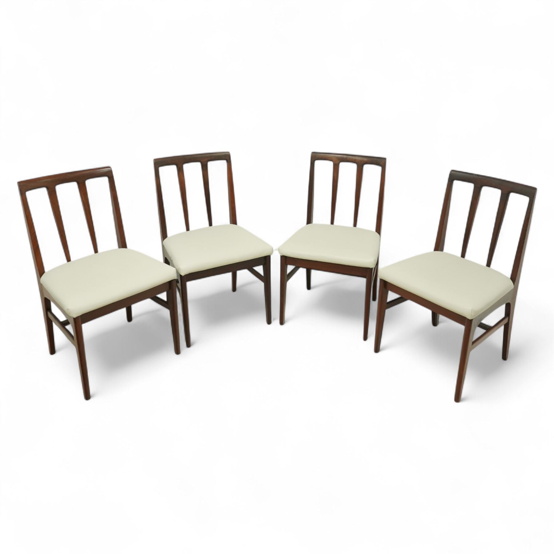 John Herbert for A. Younger  - Mid-century afrormosia teak Volnay dining table, of rectangular form with chamfered edges raised on tapering legs united by rounded stretchers, together with four afrormosia Volnay dining chairs with a gently curved top rail over triple splat open back on square tapering legs united by stretchers reupholstered in cream vinyl, chairs W50xD42xH88cm