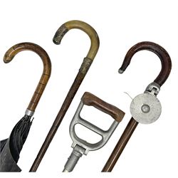 Early 20th century curved horn handle walking stick with hallmarked silver mounts, engraved L Russell 1918, together with a shooting stick by William Mills Birmingham, with leather handle, 'The Featherwaite' shooting stick and an umbrella with wooden handle