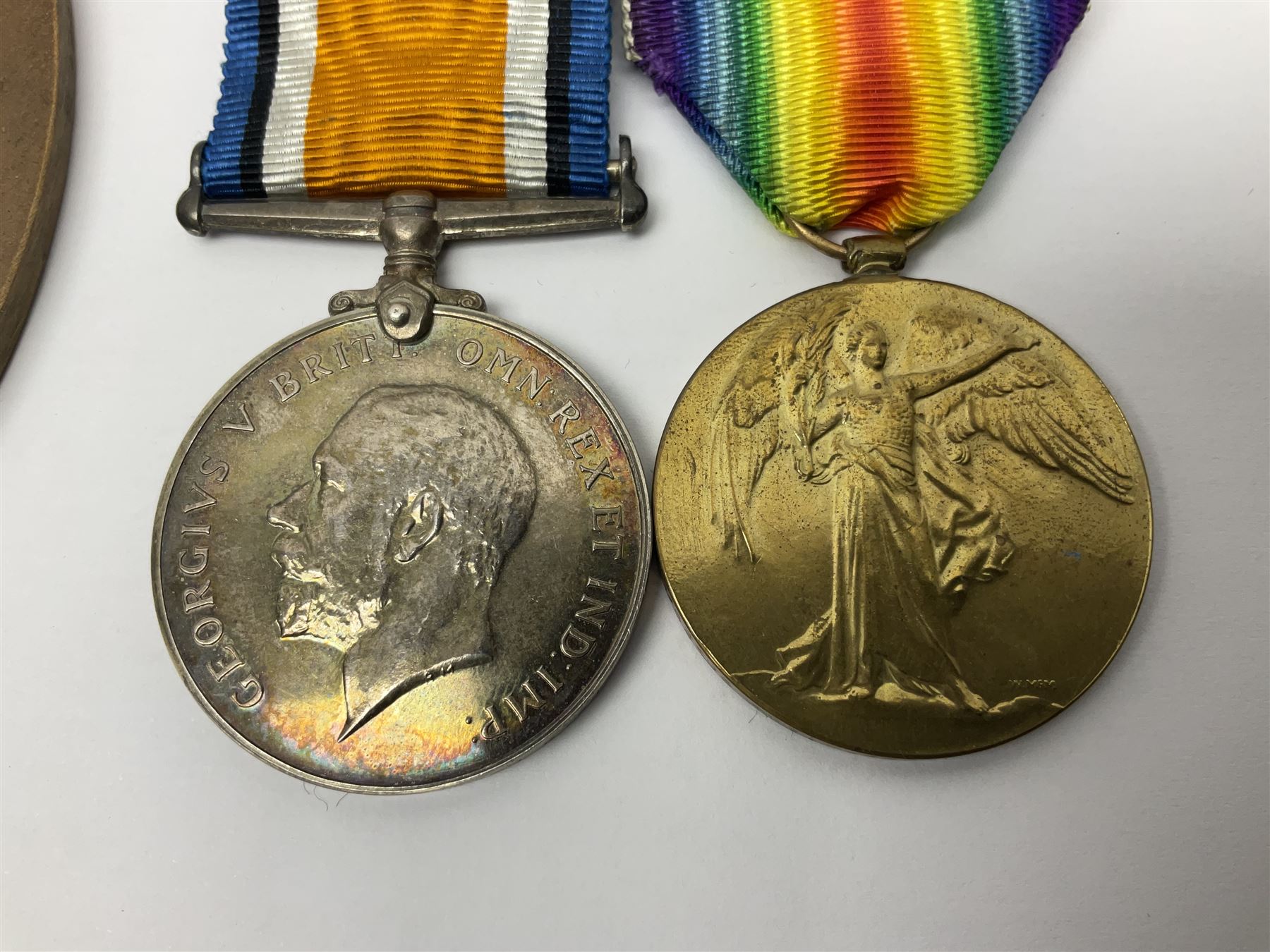WWI pair of medals comprising British War Medal and Victory Medal awarded to G/62196 Pte. H. Ferguson R. Fus. with ribbons on wearing bar; together with bronze memorial plaque to Henry Ferguson (3)