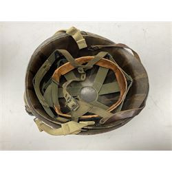 American first type paratrooper helmet with post-WW2 strap and D-rings and later 1944 liner bearing Firestone Tyre and Rubber Company mark; green textured finish