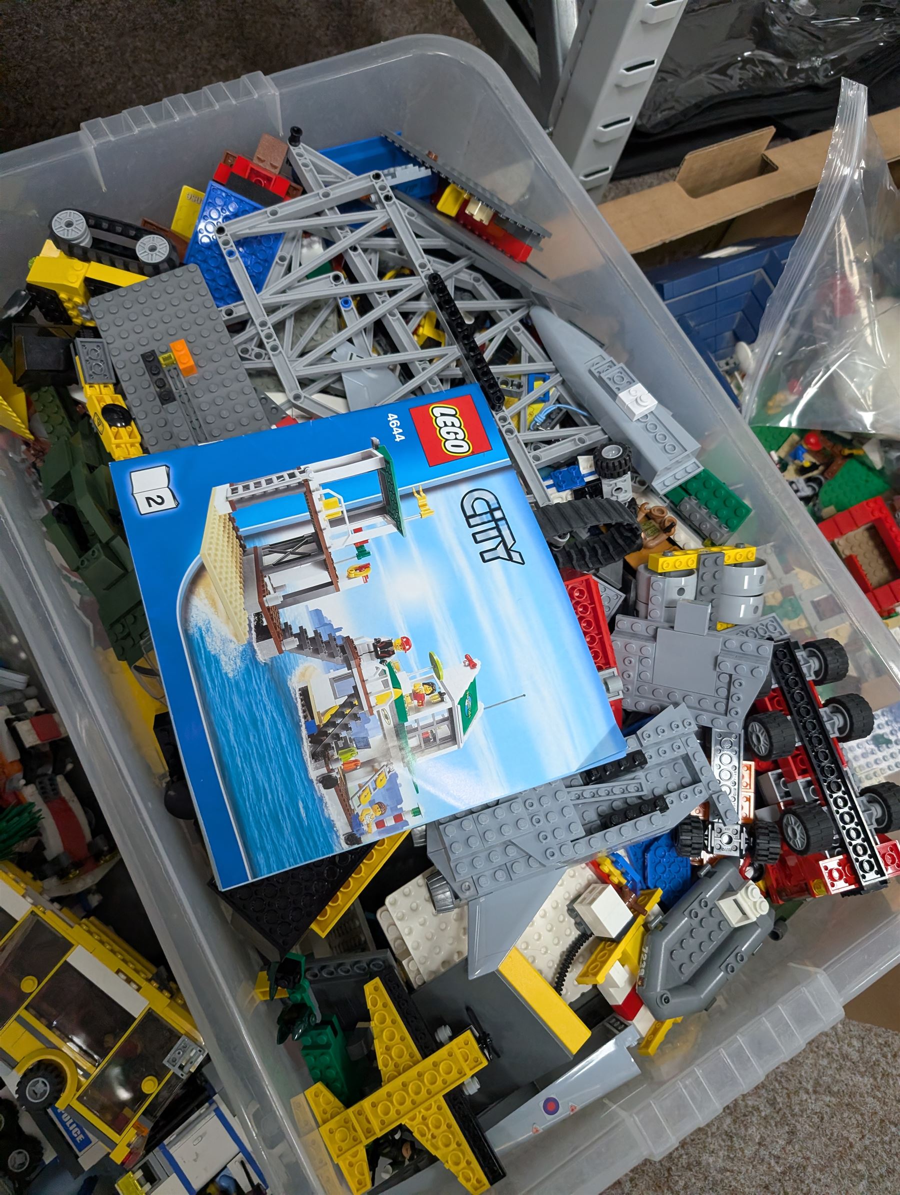Large collection of Lego, including partially built vehicles, Police Station, Lego Creator 31010 and a collection of Lego instruction booklets