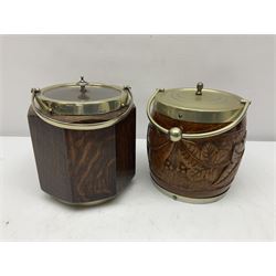 Four early 20th century carved oak biscuit barrels with silver-plated mounts 