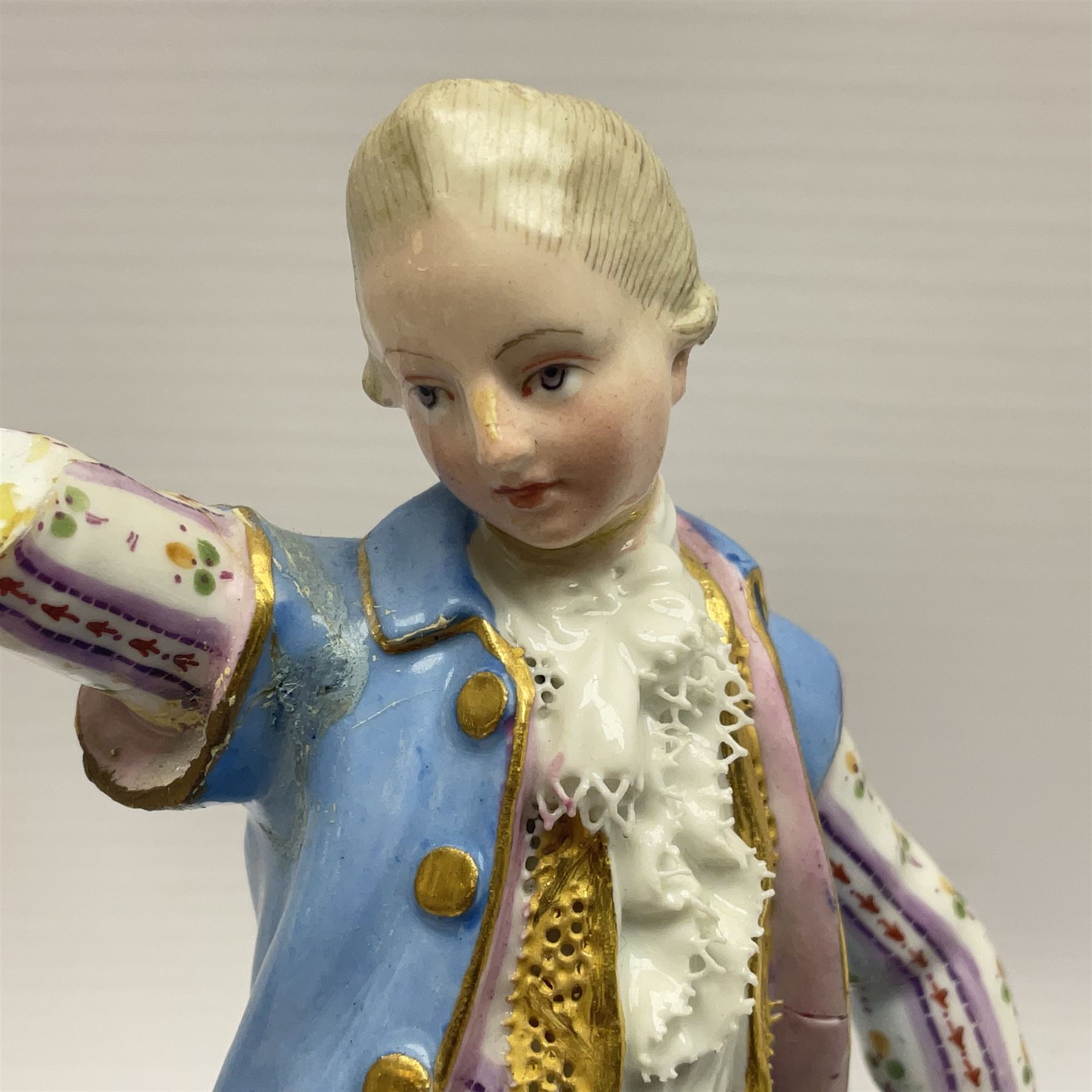 Pair of late 19th/early 20th Century Meissen figures, modelled as flower sellers, after the original by Michel Victor Acier, she holding basket of flowers, he holding flowers in his hat, each with underglaze cross swords mark beneath, tallest H16.5cm