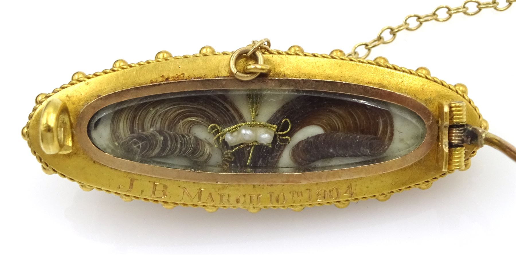 Edwardian gold black onyx brooch, with applied gold pearl set star, the glazed back with hairwork and engraved 'JB March 10th 1904', 18ct gold split pearl oval brooch and a gilt malachite brooch