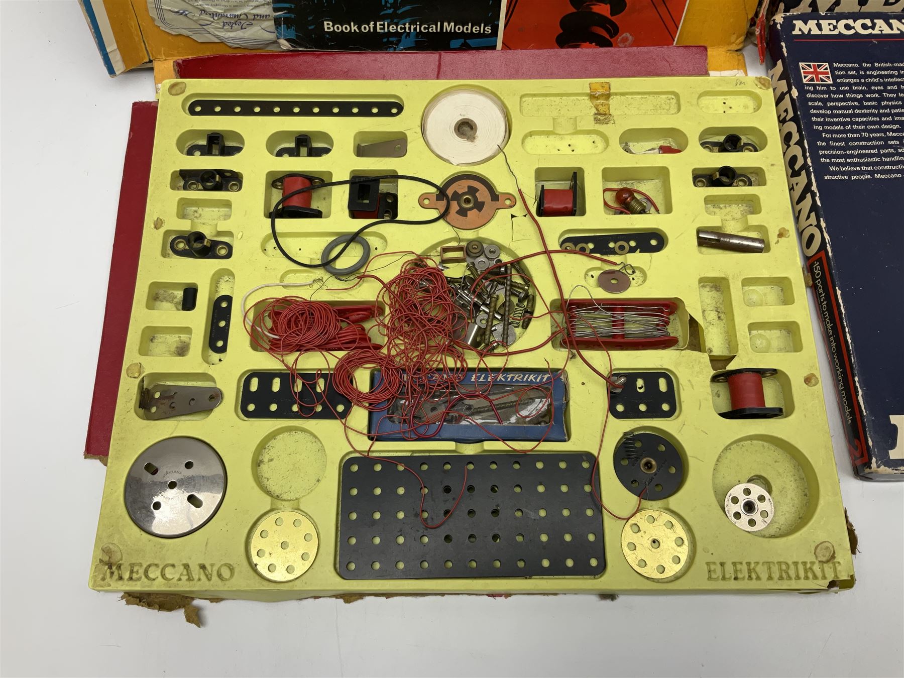 Meccano - Outfits 2, 3 & 4 with blue and yellow parts; look to be virtually complete with most apertures filled; together with a partially stocked Meccano Elekrikit; all boxed with instruction manuals (4)