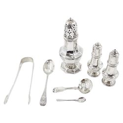 Group of silver, to include early 20th century sugar caster, of octagonal bellied form, with domed and pierced cover, upon a spreading octagonal foot, hallmarked Barker Brothers, Chester, probably 1909, date letter worn and indistinct, H15cm, pair of modern silver salt and pepper shakers, hallmarked W I Broadway & Co, Birmingham 1978, pair of George III Fiddle pattern sugar tongs, maker's mark RC, probably Randall Chatterton, 1804, George III Fiddle Shell pattern caddy spoon, hallmarked Thomas Wallis (II) & Jonathan Hayne, 1815, etc approximate total weight 7.18 ozt (223.4 grams)