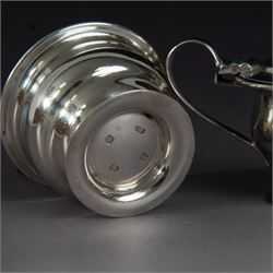 1930s silver three piece cruet set, comprising pepper shaker, open salt and mustard pot and cover, all of circular form upon circular spreading feet, hallmarked 	Atkin Brothers, Sheffield 1930, with two silver condiment spoons and blue glass liners