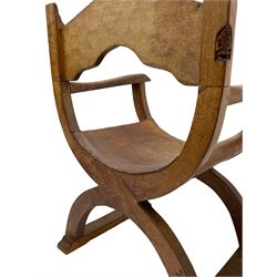 'Gnomeman' oak curved x-framed throne chair, sloped arched cresting rail carved with arcade, studded slung leather seat, the supports joined by sledge feet, rear upright carved with gnome signature, by Thomas Whittaker of Littlebeck