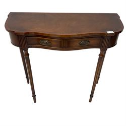 Regency design mahogany serpentine console table, fitted with single drawer disguised as two with cockbeaded facia, raised on fluted tapering supports