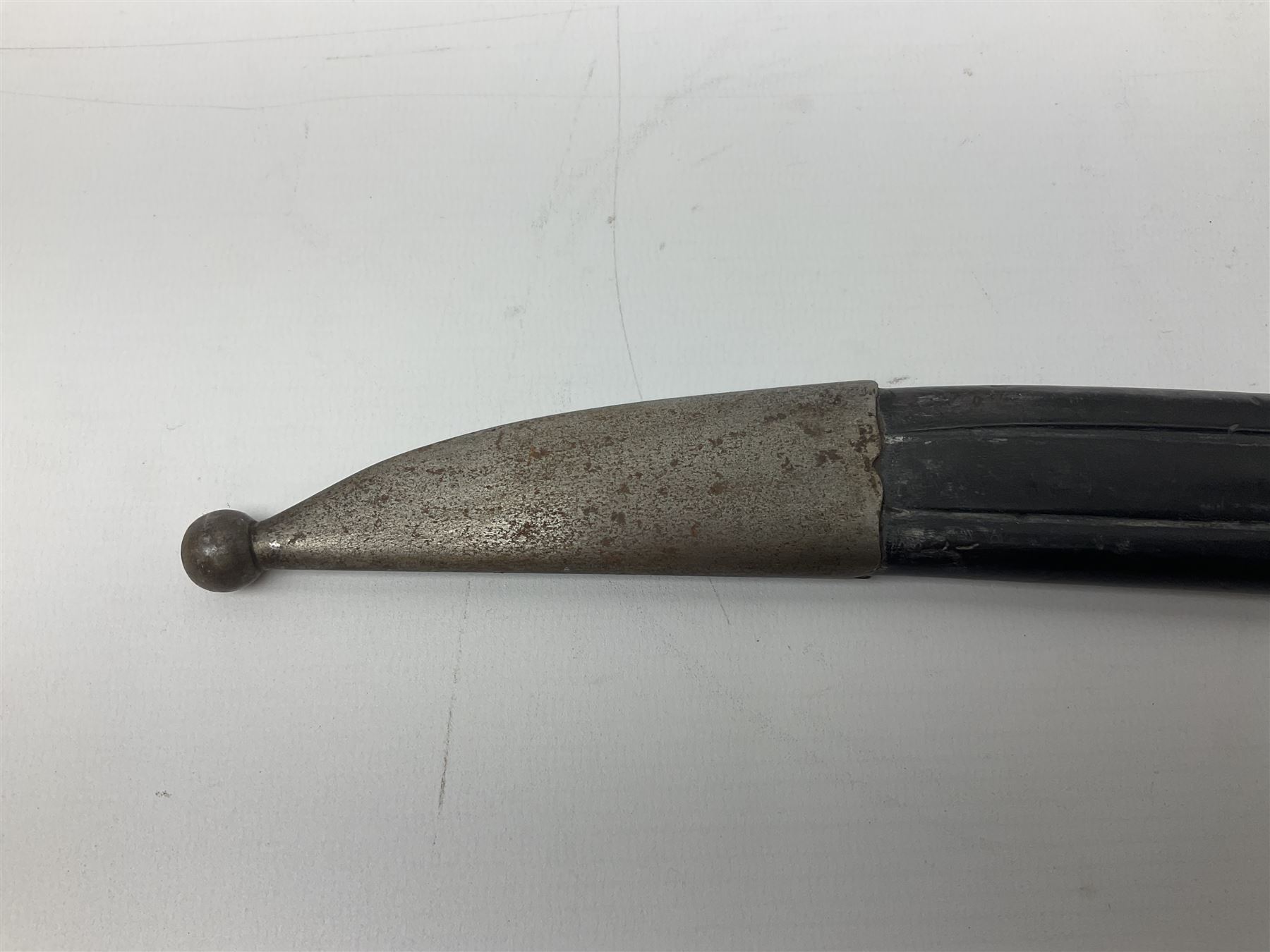 Turkish Model 1874 sword bayonet with 57.5cm curving steel fullered blade and chequered black grip, in steel mounted leather scabbard L75.5cm overall