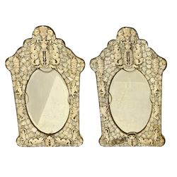 Pair 19th century French Dieppe bone and ivory wall mirrors, the oval bevelled mirror plates within rectangular frames with shaped tops, profusely decorated with ivory leaves, further detailed with carved bone armorial type crest inscribed 'SGOTORVM', putti, fish and mask heads, H81cm W48cm