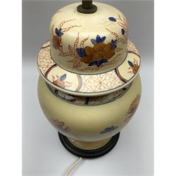 Oriental style table lamp modelled as a ginger jar, with foliate decoration in blue and red, including fixtures H43.5cm.