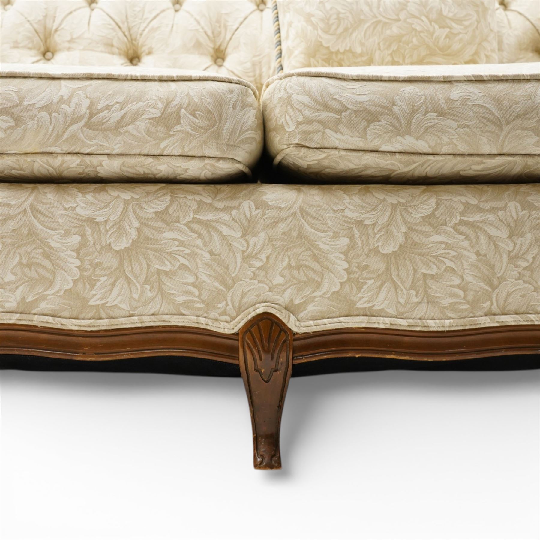 Mahogany framed three seat sofa in the Louis XV style, the shaped buttoned back above loose seat cushions and scrolling arms, raised on cabriole legs with shaped apron