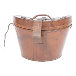 Bowler hat, by Moores, with retail label for Kendall of Scarborough, with brown leather top hat box having a handle to the lid and buckle fastening, lined in red velvet, marked W.B. to the front 