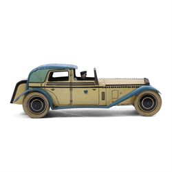 Wells tinplate clockwork limousine, the cream body, with blue roof and lithographed details, with driver and key, H8cm, L23cm