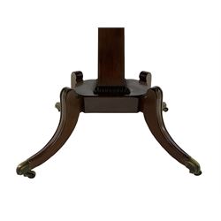 Regency mahogany dining table, rectangular top with rounded corners and reeded edge, raised on square pedestal with platform, terminating to sabre supports with brass cups and castors