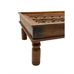 Eastern hardwood door coffee table, decorated with foliate carving and metal work, turned supports