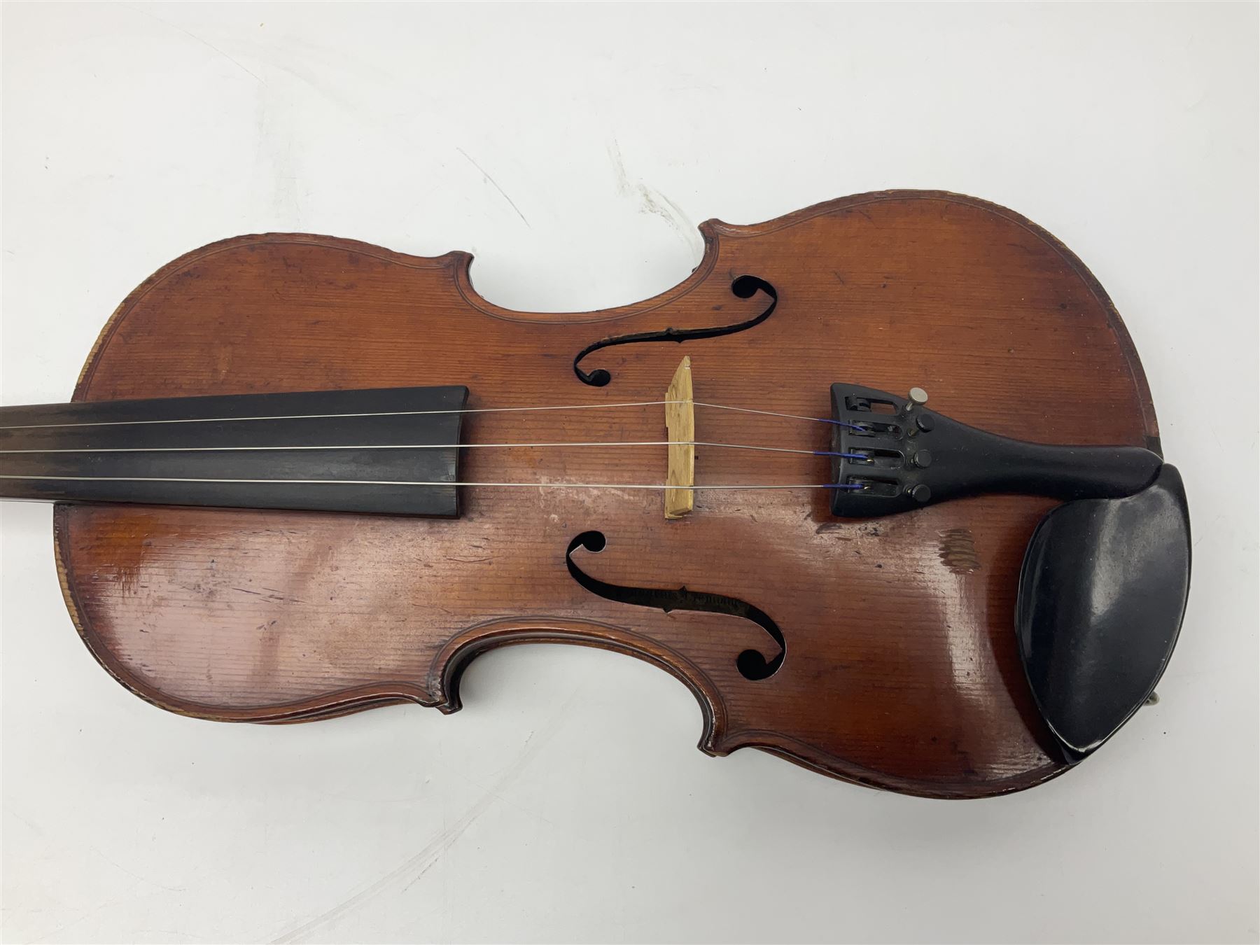 German violin c1890 with 36cm two-piece maple back and ribs and spruce top; bears label 'Antonius Stradivarius Cremona Faciebat Anno 1729' L59.5cm overall; in ebonised wooden 'coffin' case; and two German violins c1890 for completion - one bearing a Stradivarius label, the other a Ruggeri label; both in carrying cases (3)