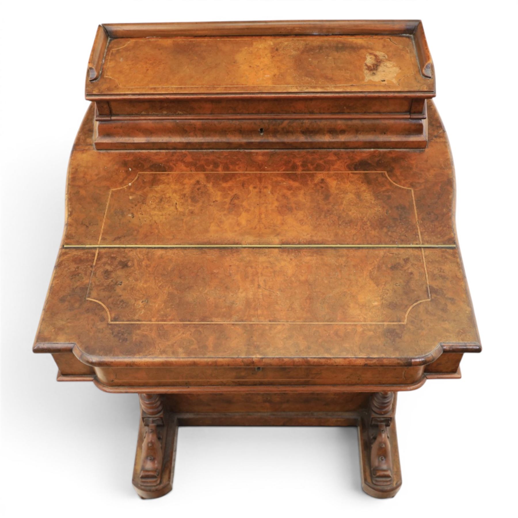 Victorian burr walnut Davenport, with hinged stationary top and slope, pull out writing surface with tooled green leather inset top, carved and turned front supports, flanked by two cupboard doors, raised on castors 