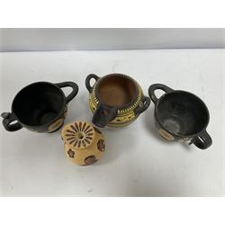 Four examples of reproduction Ancient Greek pottery, to include two skyphoi decorated with the Owl of Athena, standing between two sprays of olive in the manner of 5th century, both signed Attic 500 B.C,  terracotta twin handled vase with spout decorated in the Corinthian Geometric style, in the manner of 6th Century, signed beneath, and a further jug in the 7th Century Corinthian style decorated with flowers and birds