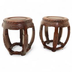 Pair of early 20th century Oriental hardwood barrel seats, of drum form with shaped apron and pierced panels, carved with stylised scrollwork and studded detail to the top