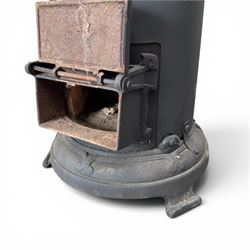 Late Victorian cast iron stove of small proportions, decorated with scrolls and central rosette to the top