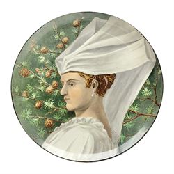 19th century continental pottery charger, depicting a woman in a white veil with pinecones on a green ground, with indistinct signature to the back, D31cm