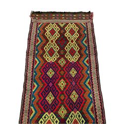 Flatweave geometric design rug, decorated with trailing hooked medallions within zig-zag bands, bright multi-coloured ground 